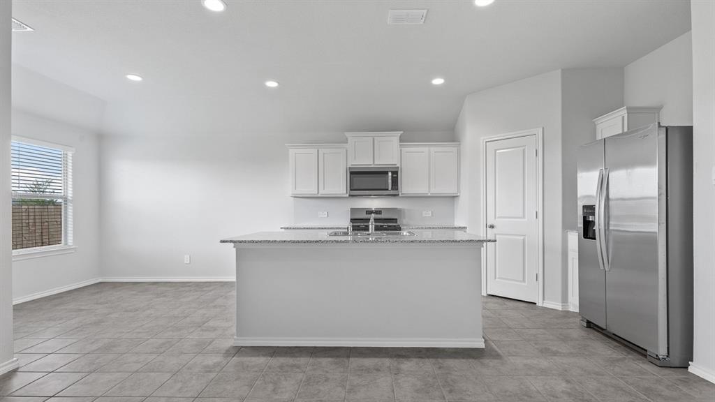 a kitchen with stainless steel appliances a sink stove and refrigerator