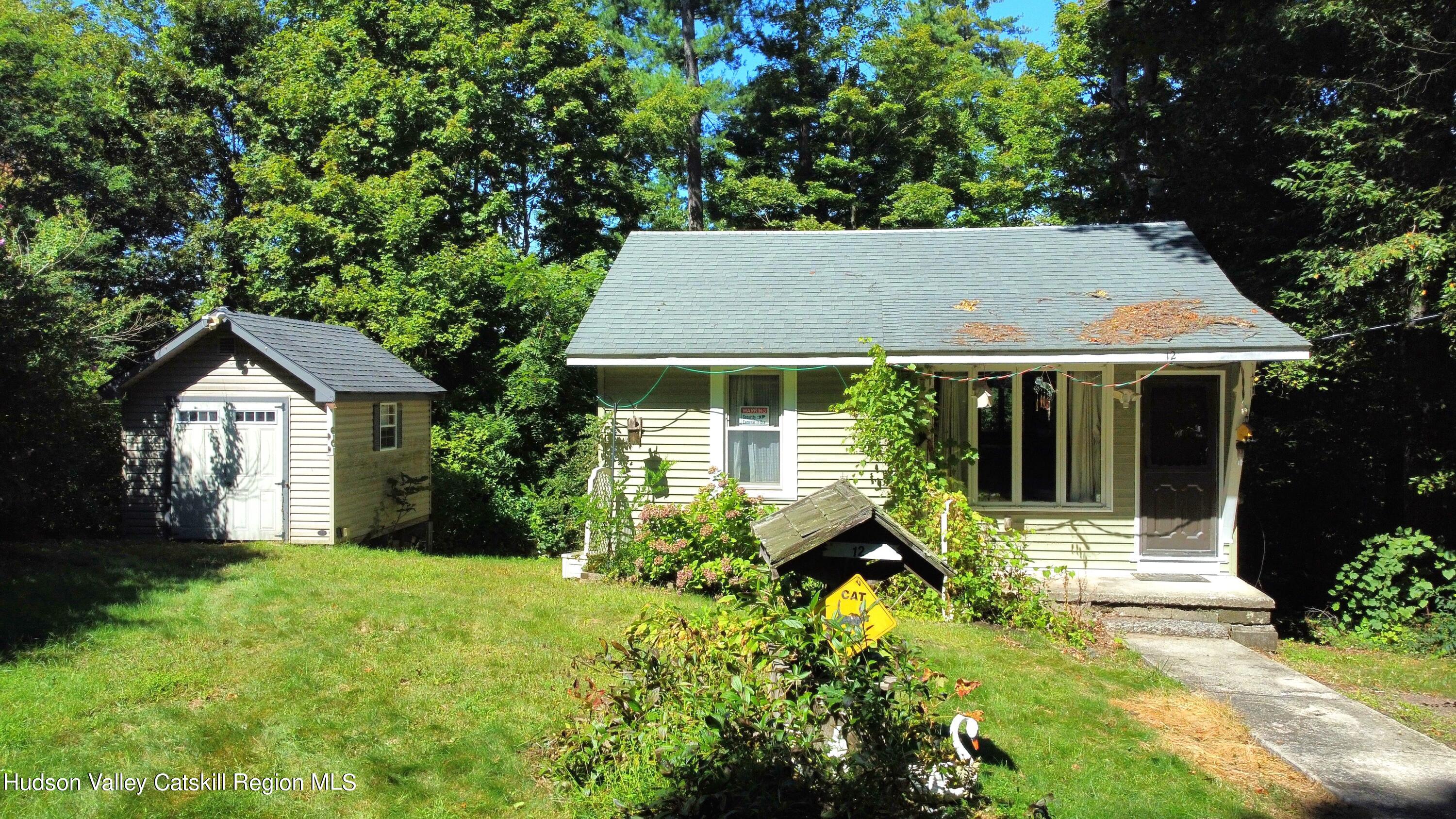 a view of house with a yard