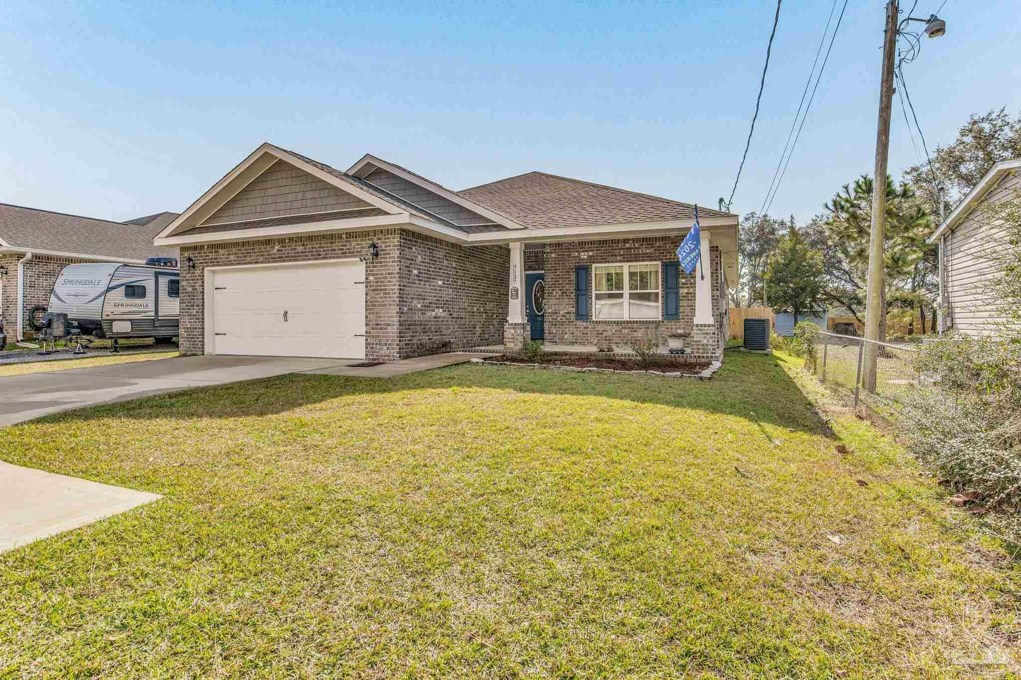 a view of a house with a yard and garage