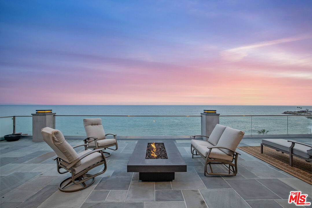 a terrace with outdoor seating and city view