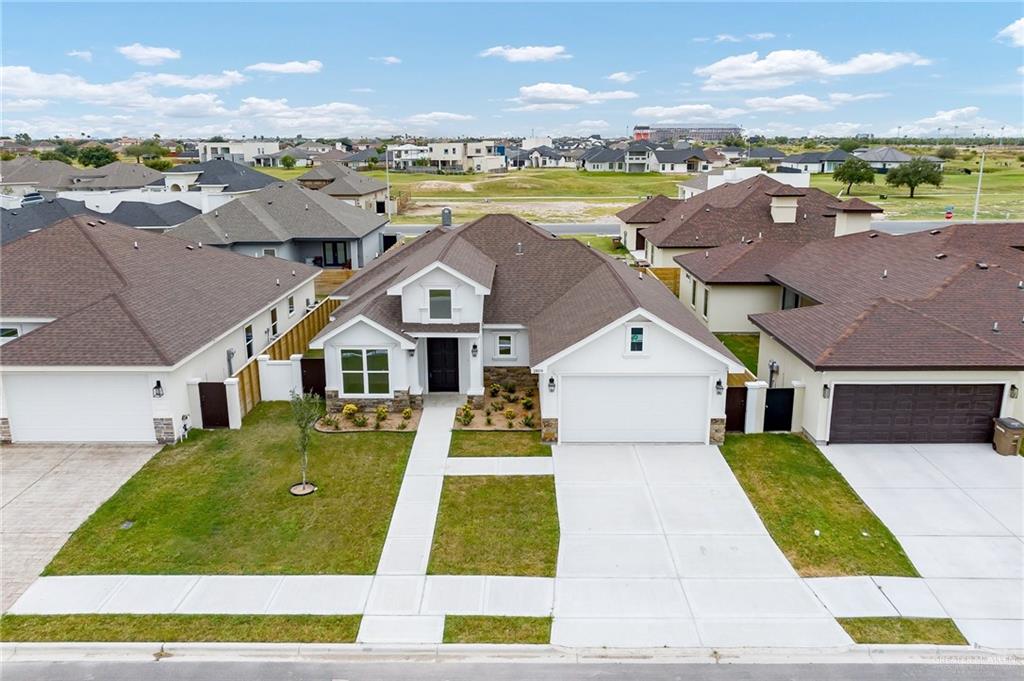 a aerial view of a house with a big yard and large trees