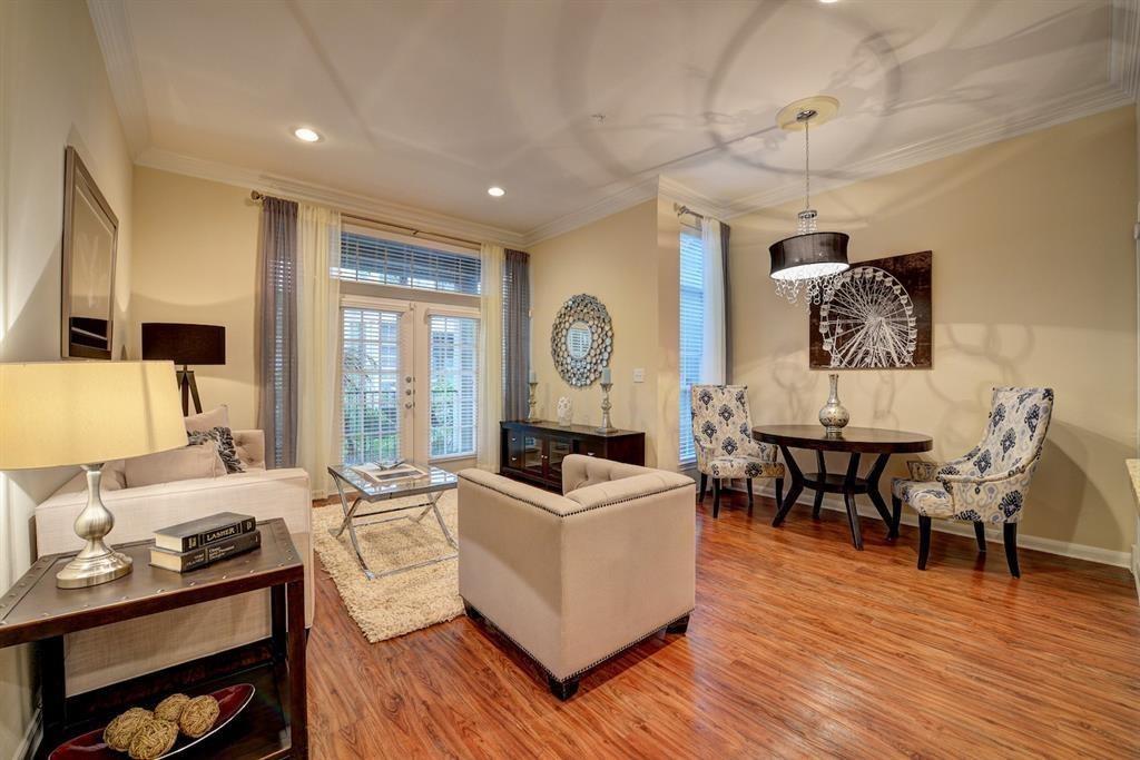 a living room with furniture and a wooden floor