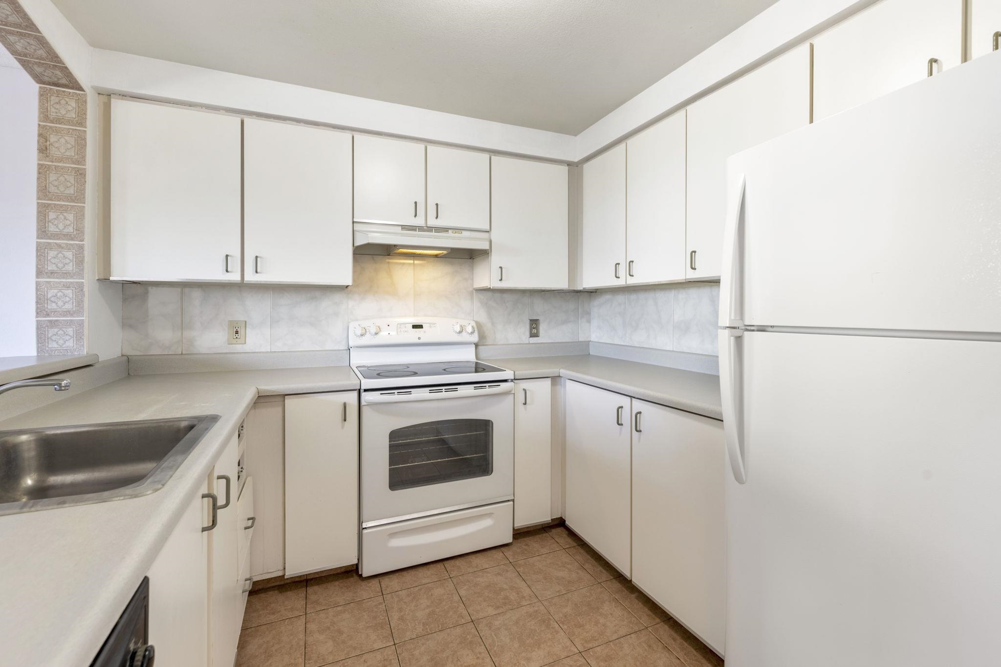 a kitchen with cabinets appliances and a sink