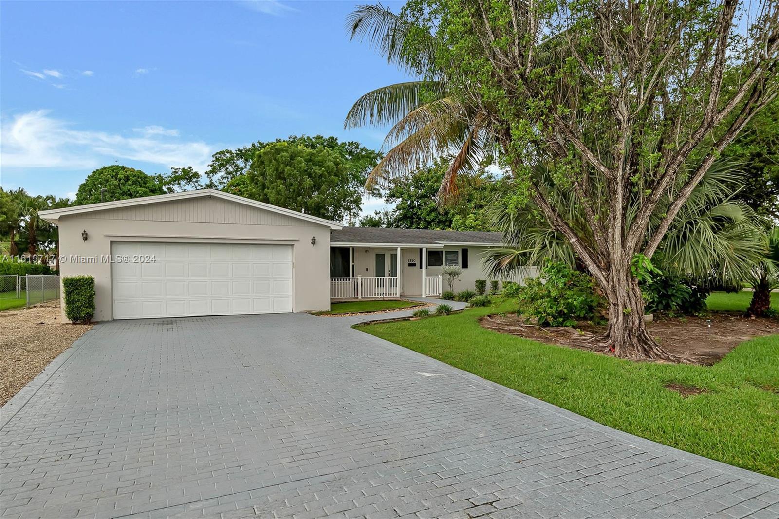 a view of a house with a yard and garage