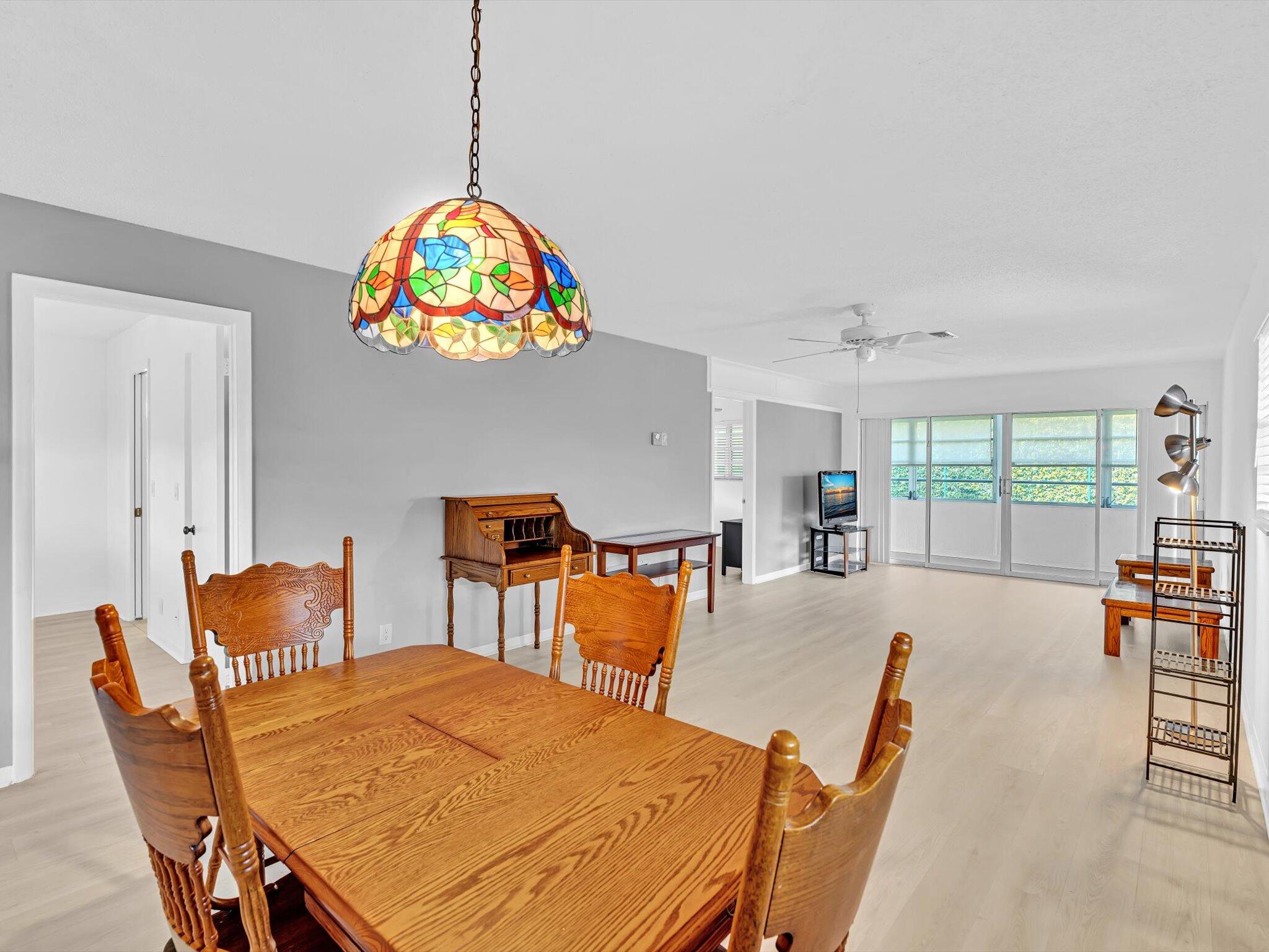 a view of a dining room with furniture a livingroom and chandelier