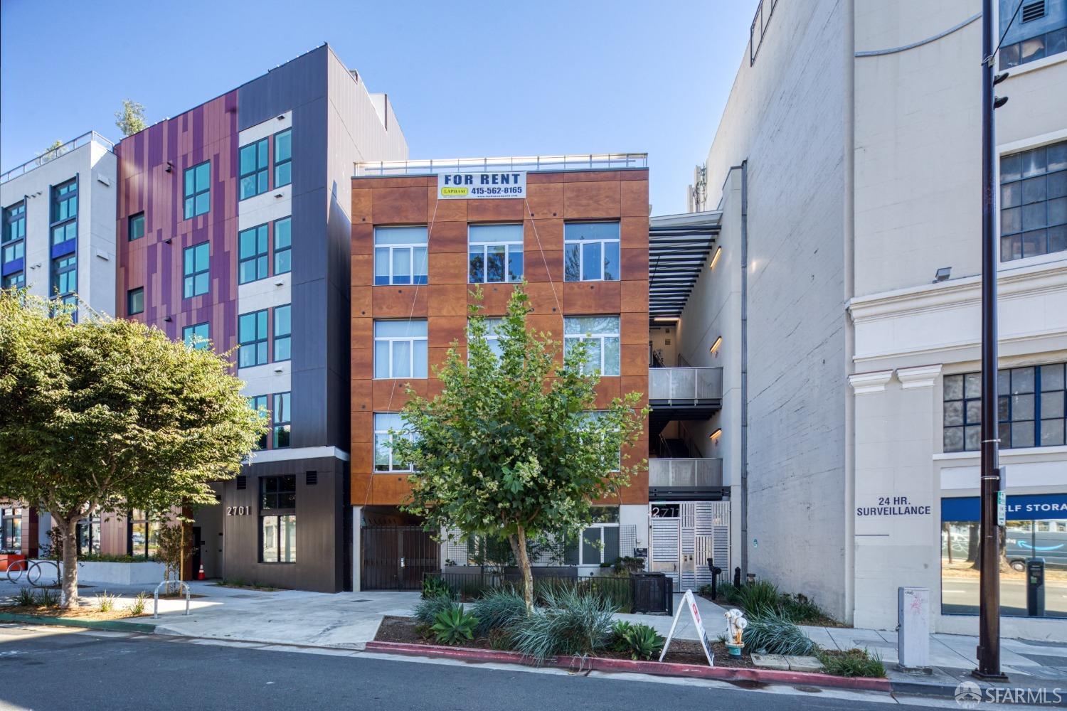 a front view of a multi story building with a yard