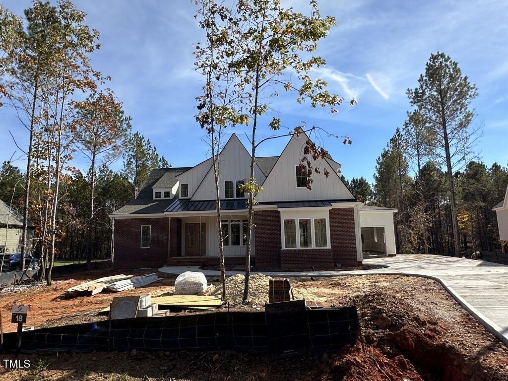 a front view of a house with sitting space and swimming pool