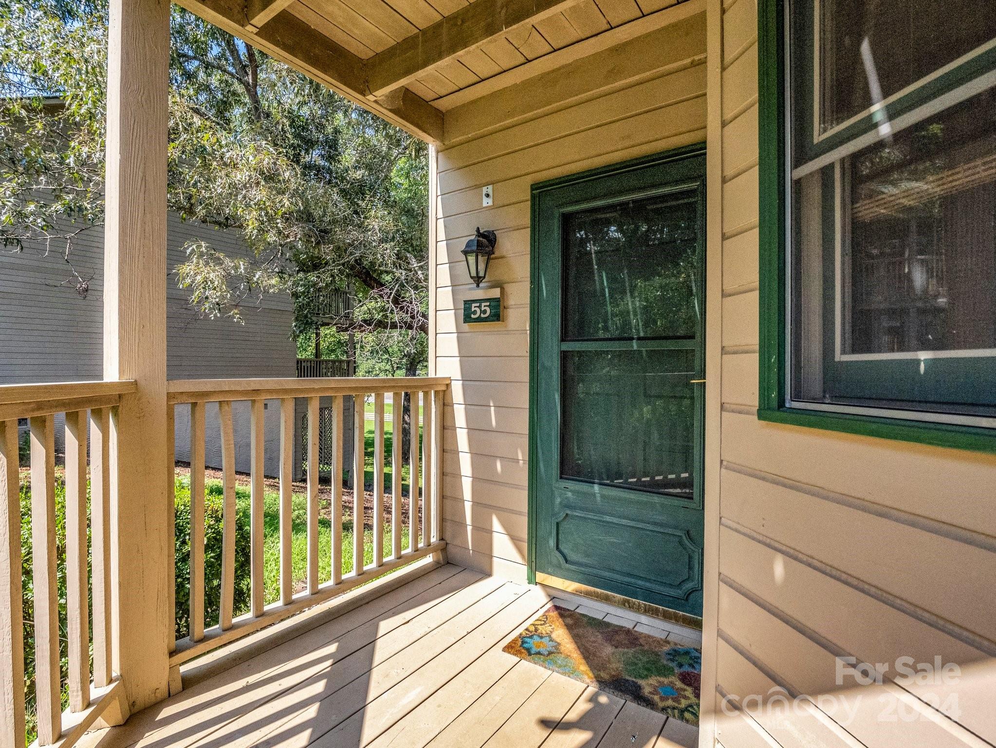 a view of a glass door with a yard from a window