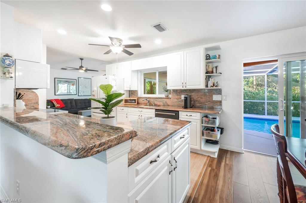 a kitchen with stainless steel appliances granite countertop a stove and a sink