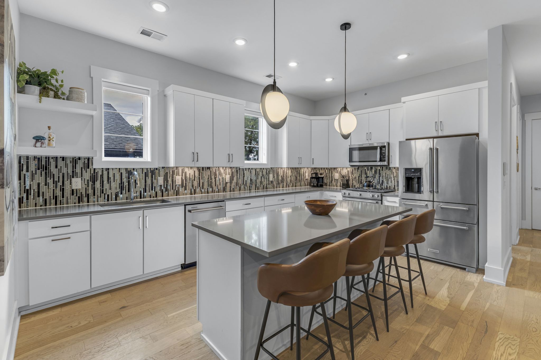 a kitchen with granite countertop a sink a center island a refrigerator and cabinets