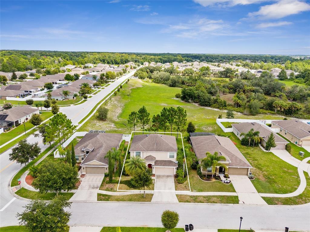 an aerial view of residential houses with outdoor space and swimming pool