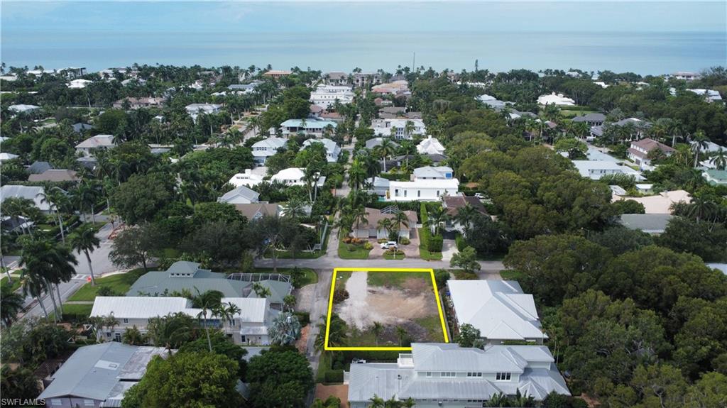 an aerial view of residential houses with outdoor space and lake view