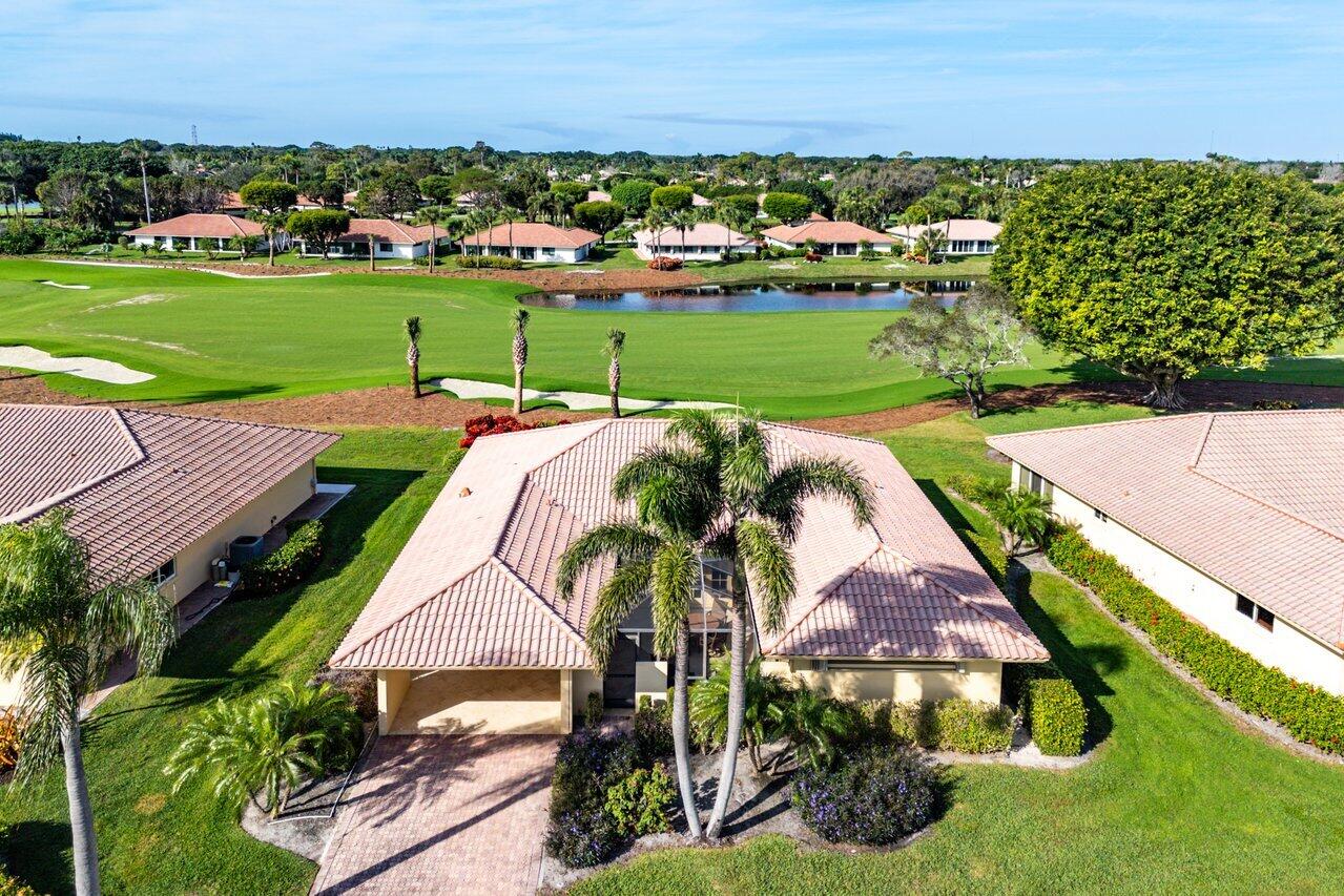 an aerial view of a house with outdoor space trees all around