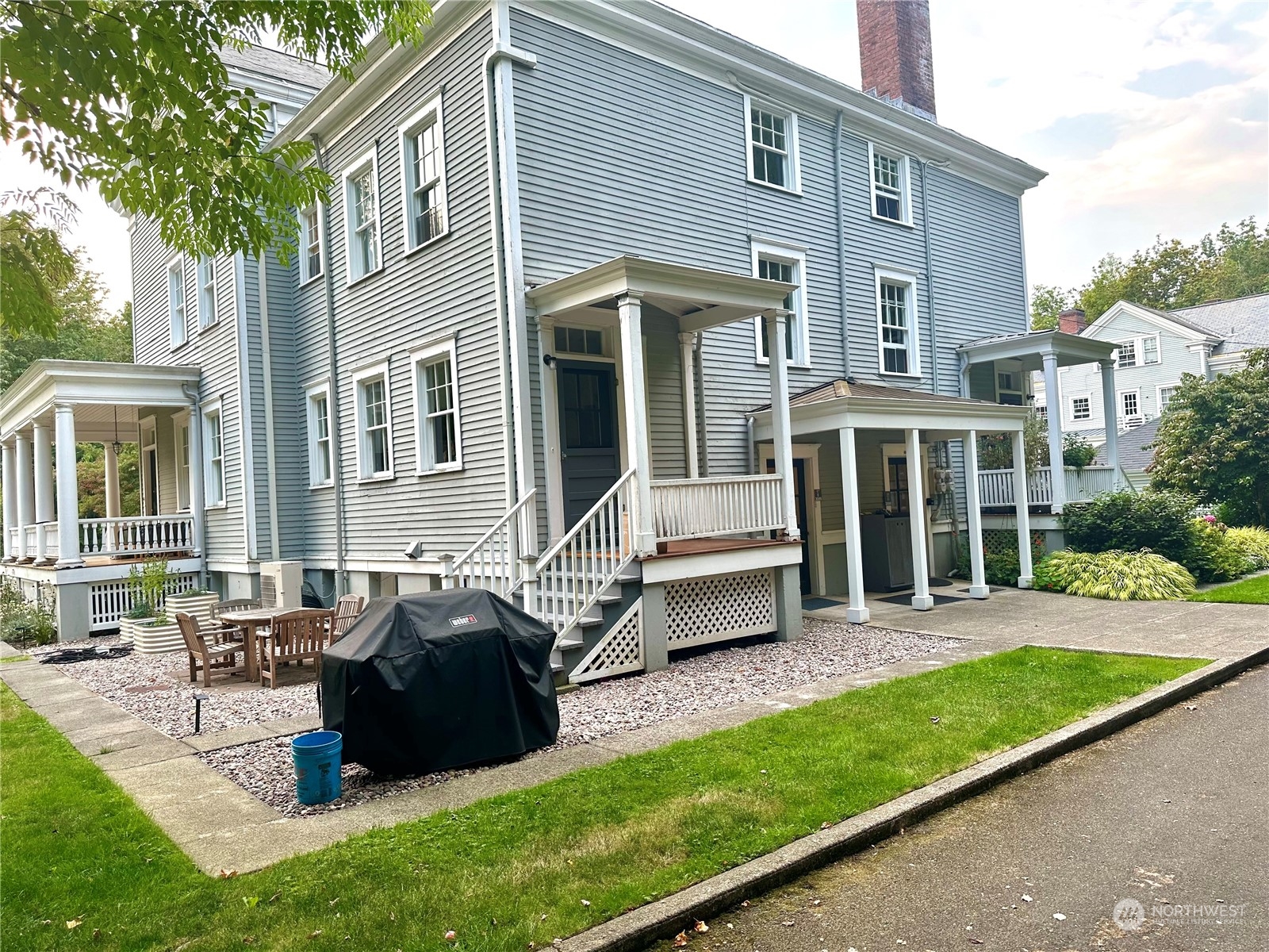 a view of a house with a patio and a yard