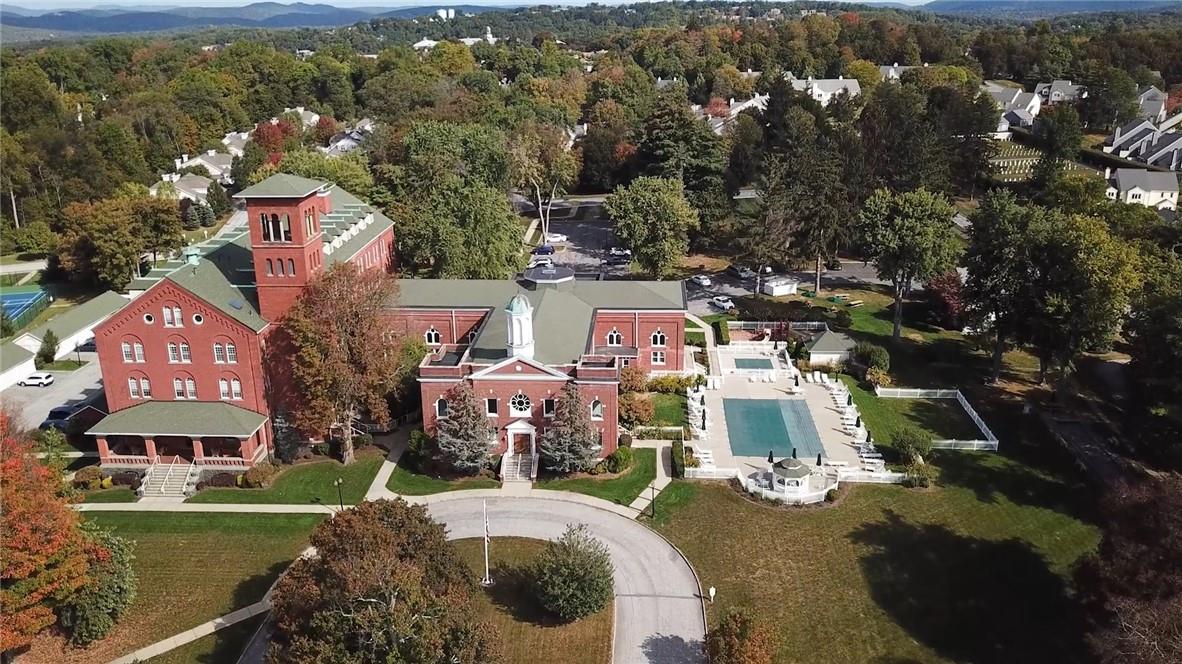 an aerial view of a house with a garden and lake view