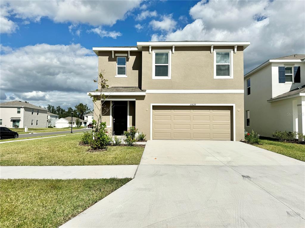 a front view of a house with a yard and garage