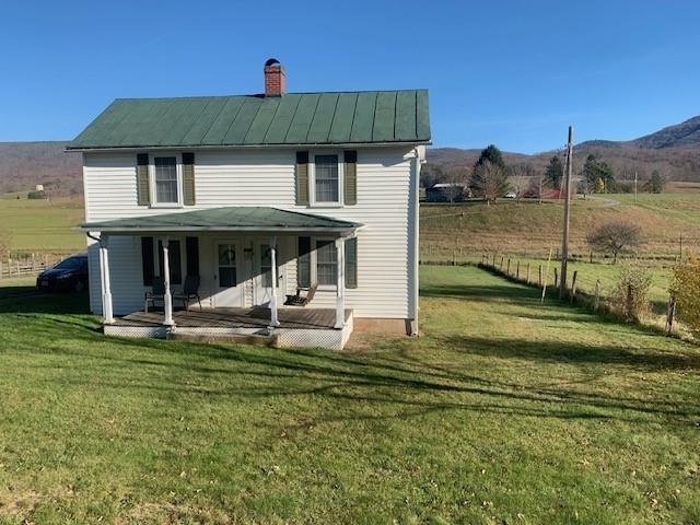 a view of a house with a yard porch and sitting area