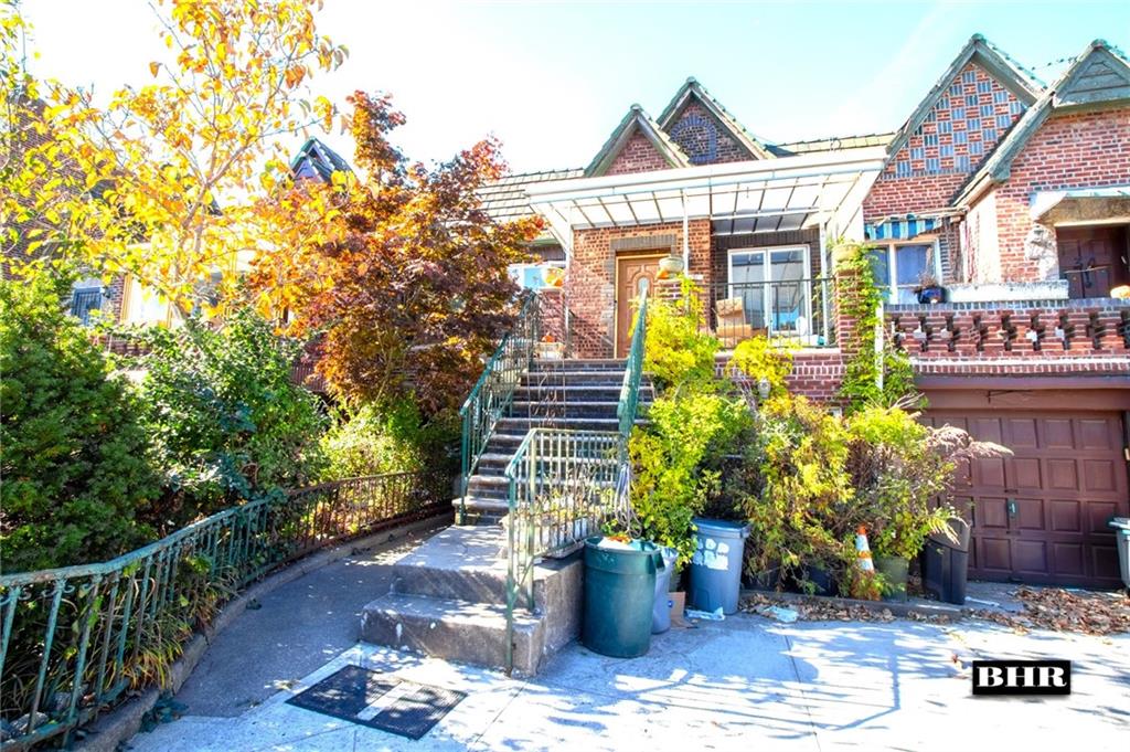 a front view of a house with plants