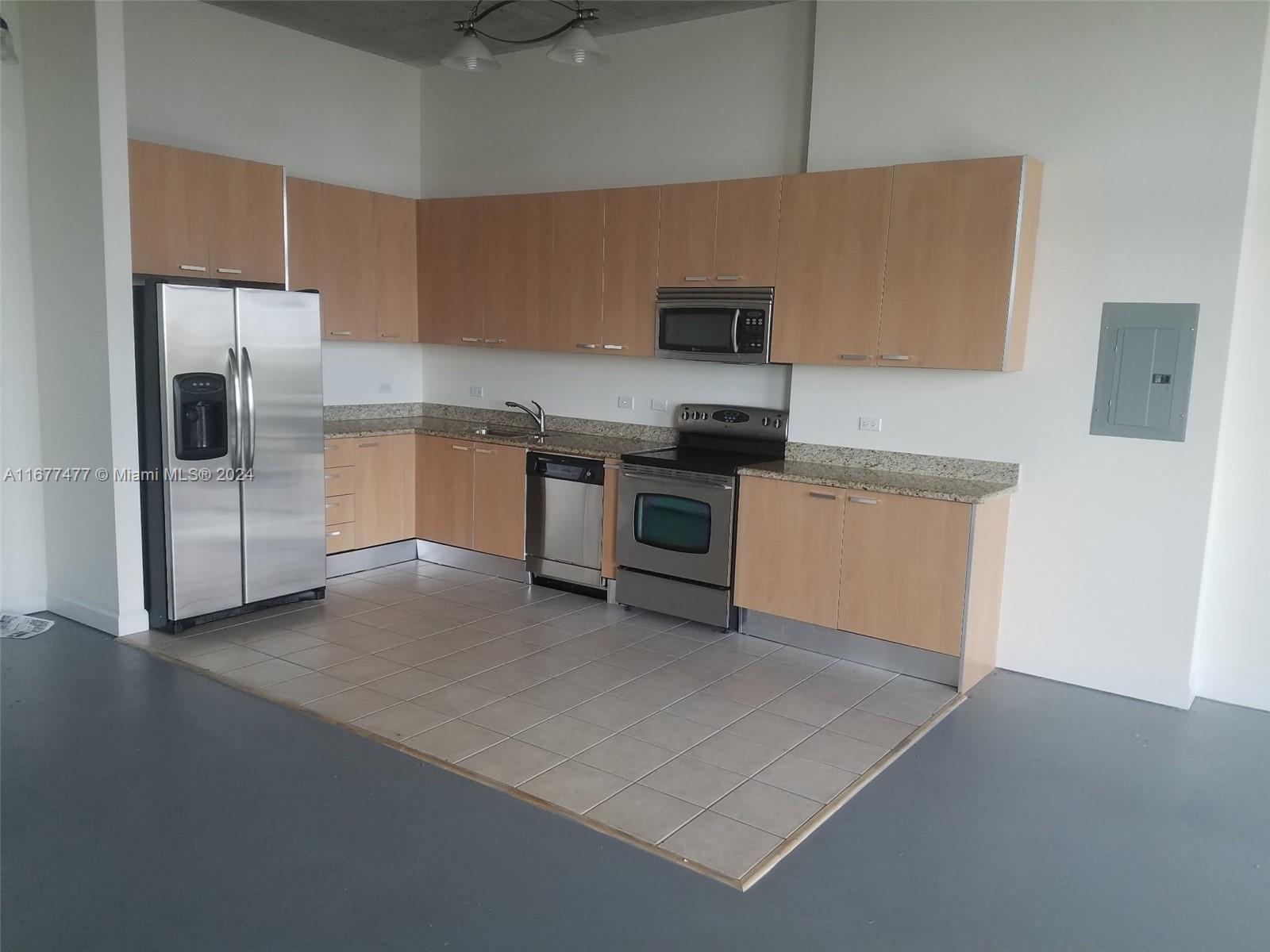 a kitchen with stainless steel appliances a stove a refrigerator and a sink