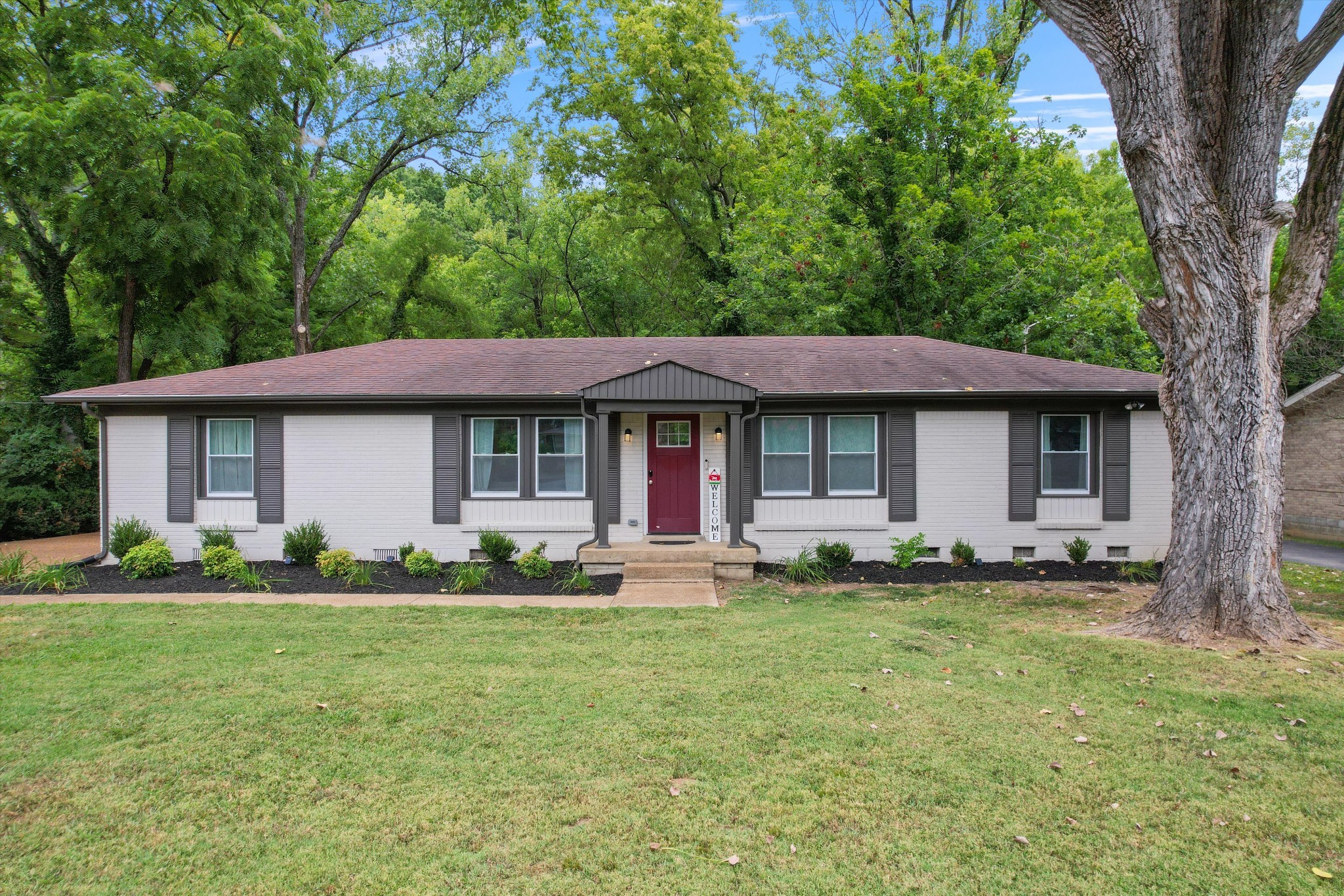 a front view of a house with a garden and porch