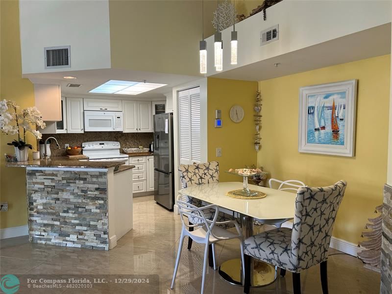 a kitchen with stainless steel appliances kitchen island granite countertop a sink and cabinets