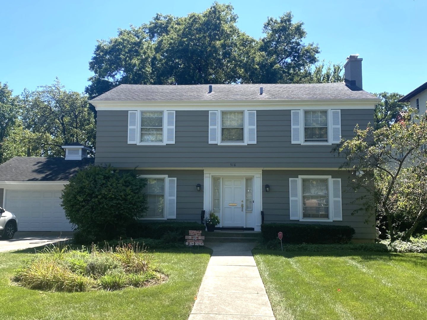 a view of a house with garden and yard