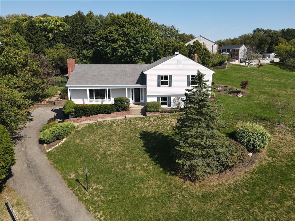 a view of house with a yard