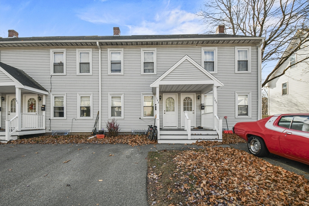 a front view of a house with parking space