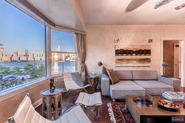 a living room with furniture and a floor to ceiling window