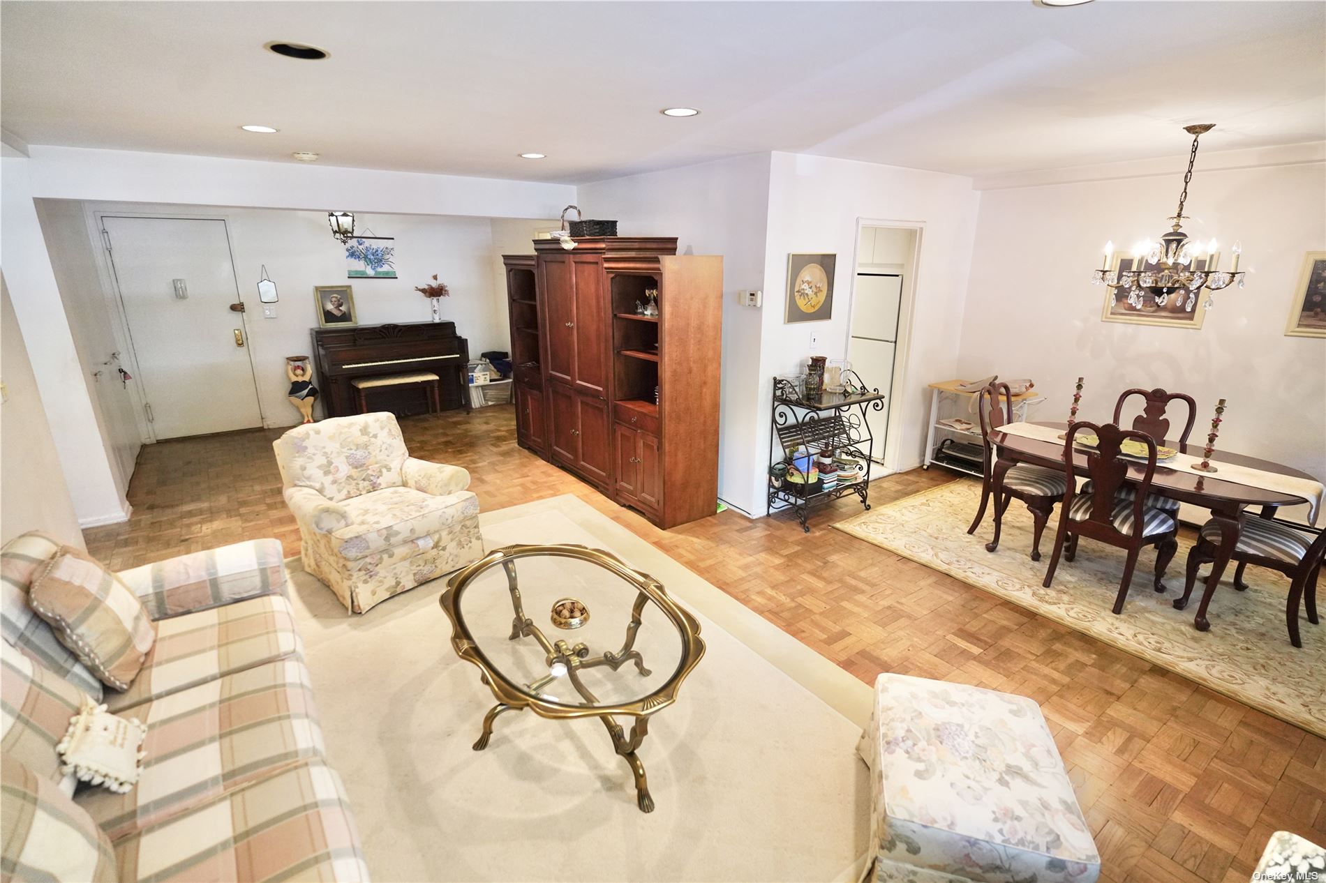 a living room with furniture and view of kitchen