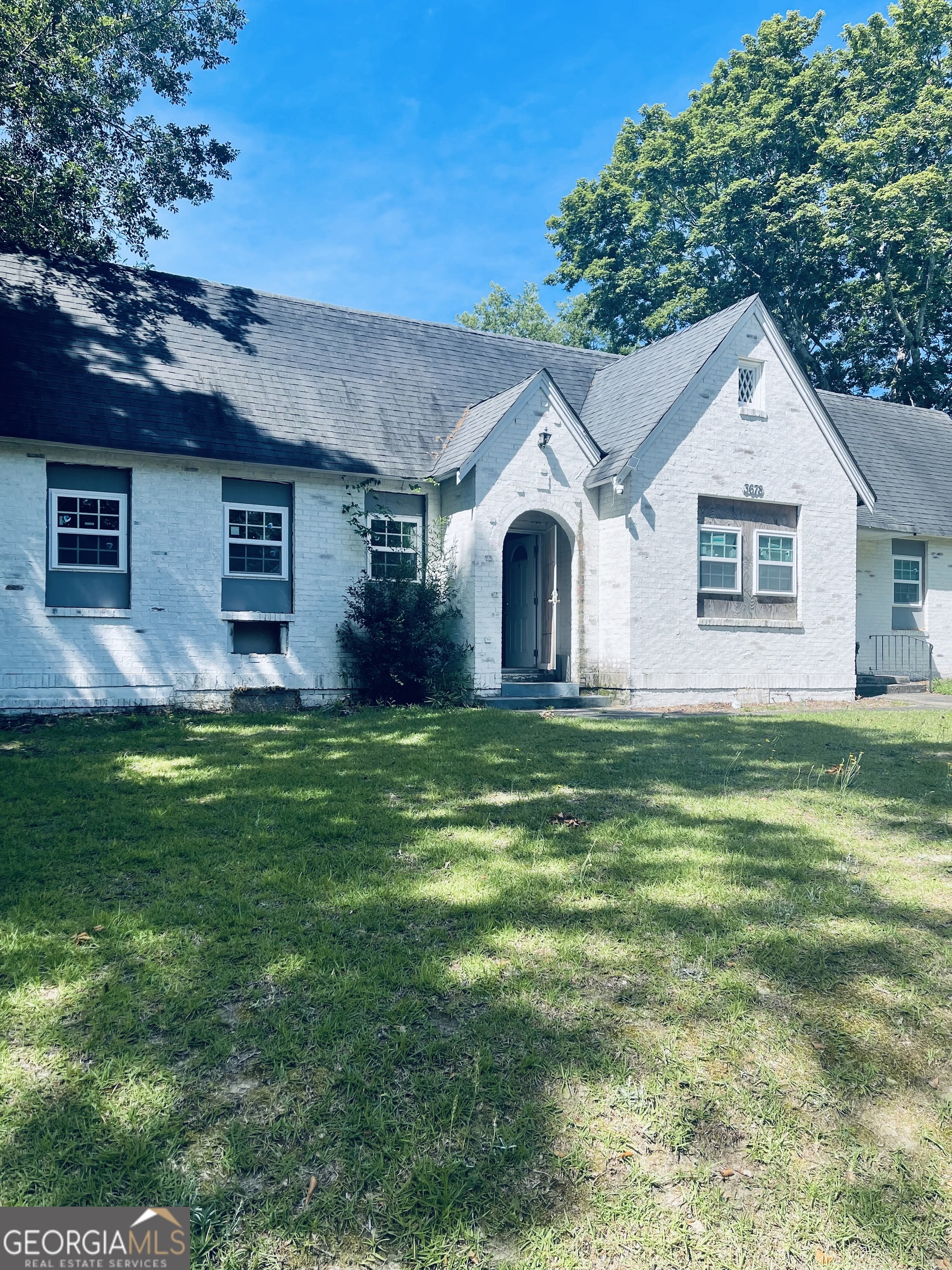 a front view of house with yard and green space