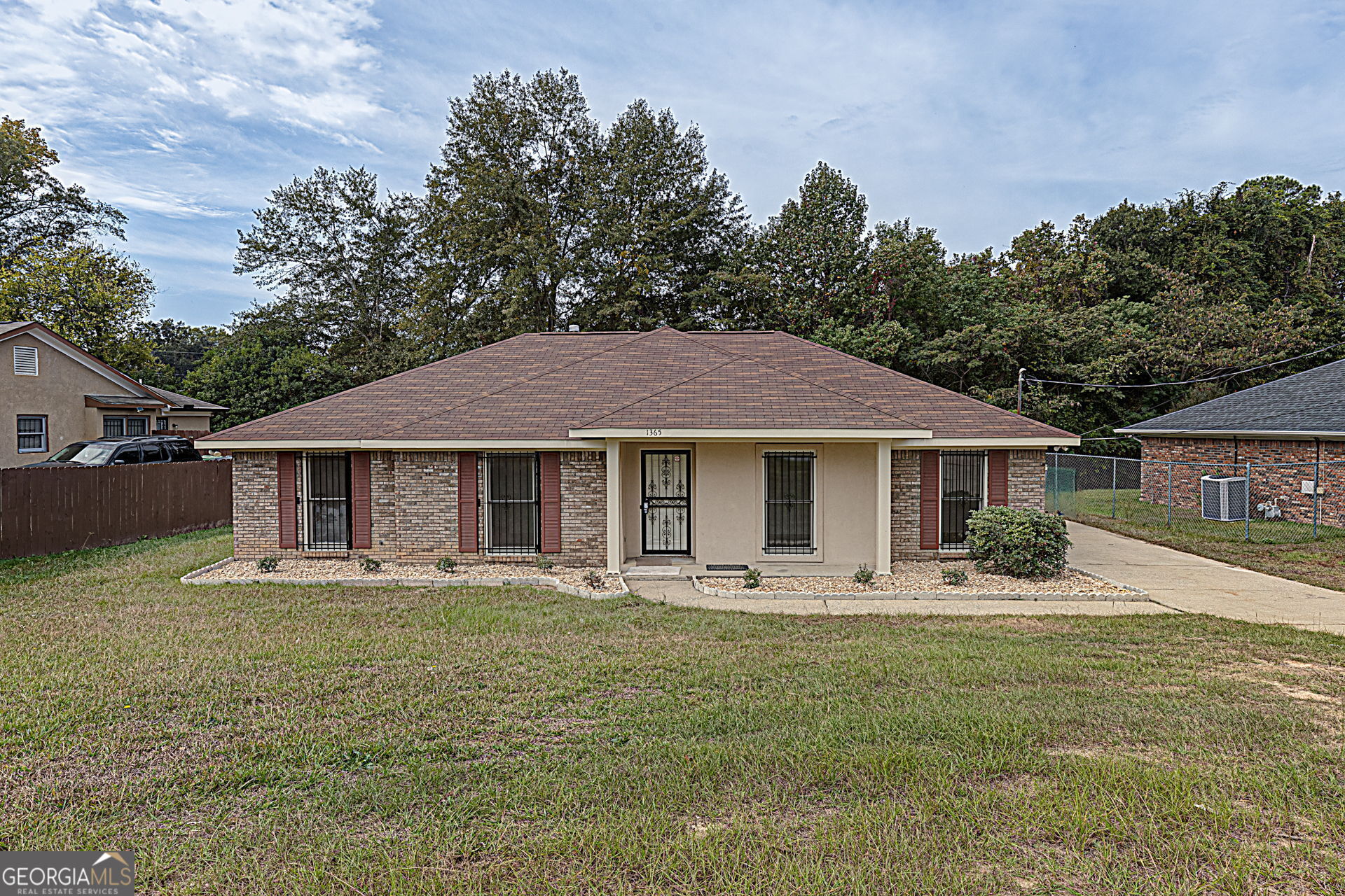 a front view of a house with a yard and trees