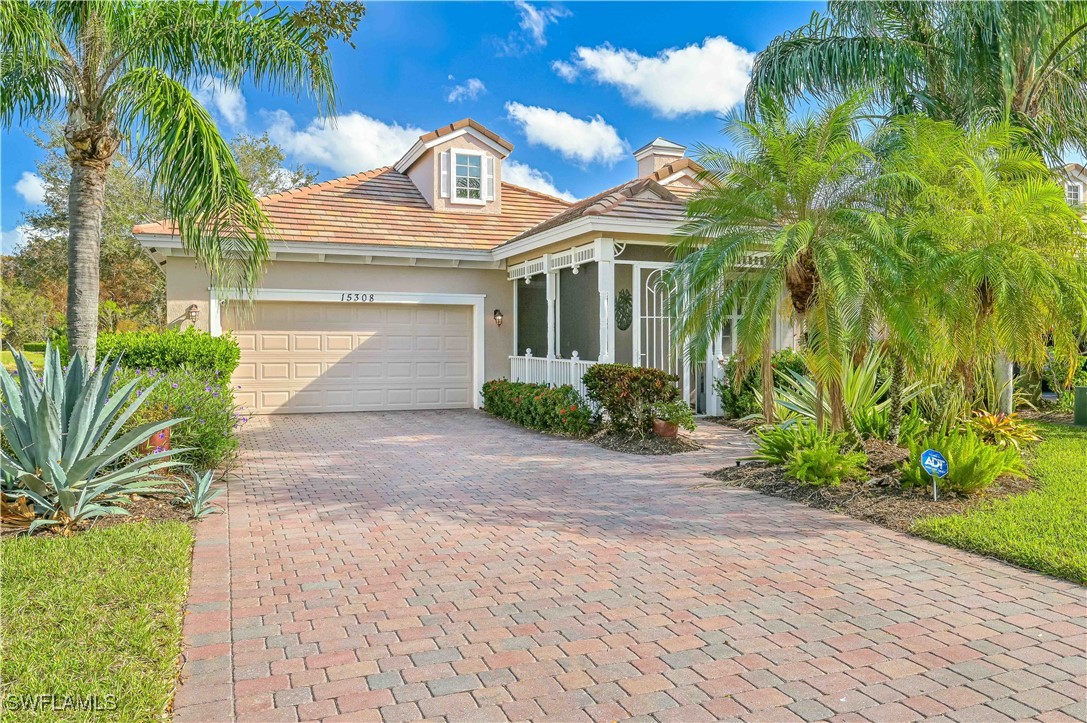 a front view of a house with a yard and a garage