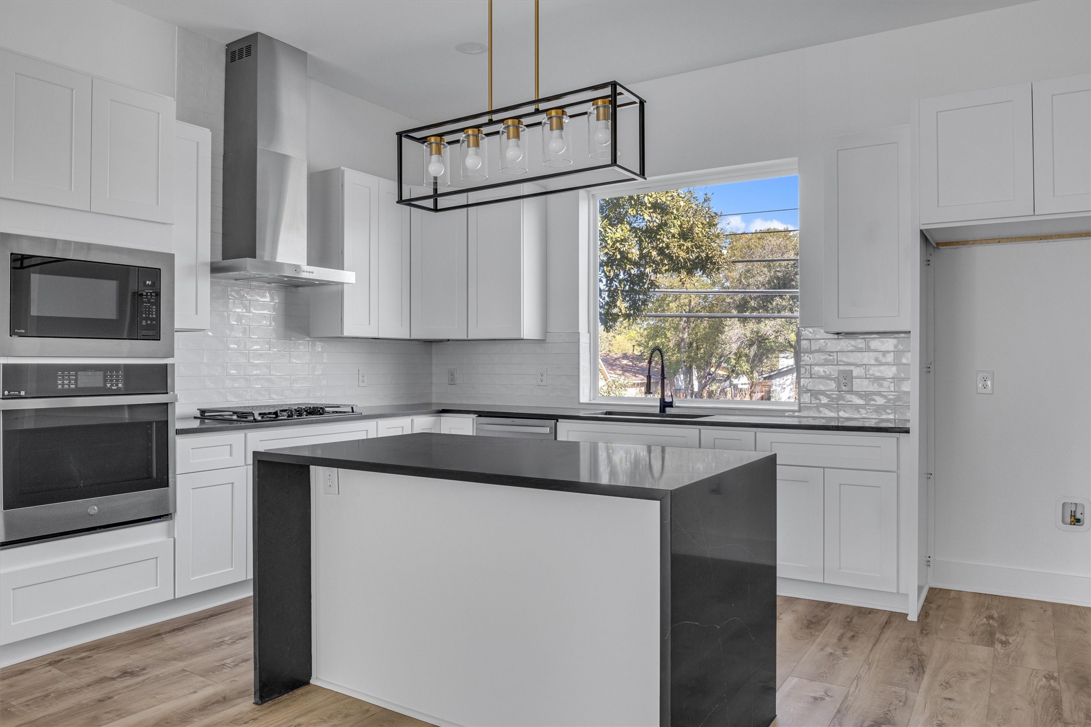 a kitchen with granite countertop white cabinets and white appliances