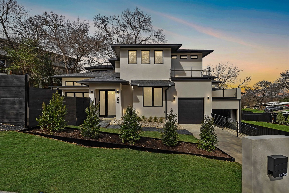 a front view of a house with a yard and outdoor seating