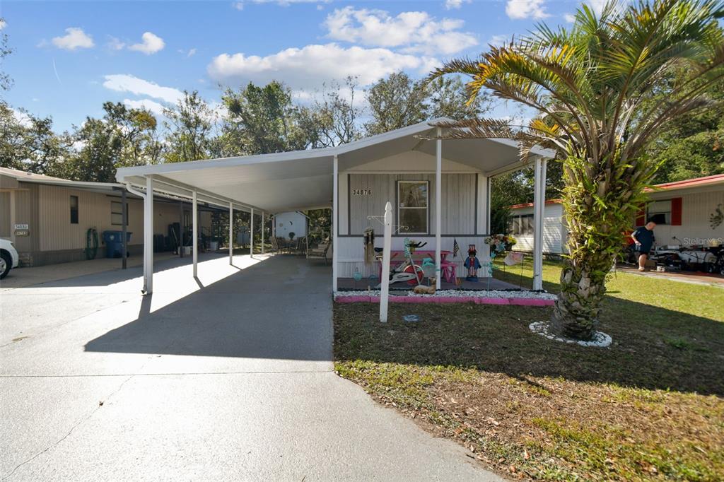 a view of a house with backyard porch and sitting area