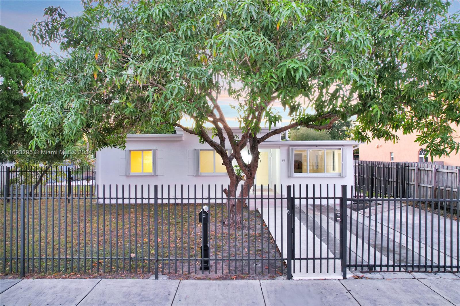 a front view of a house with a garden