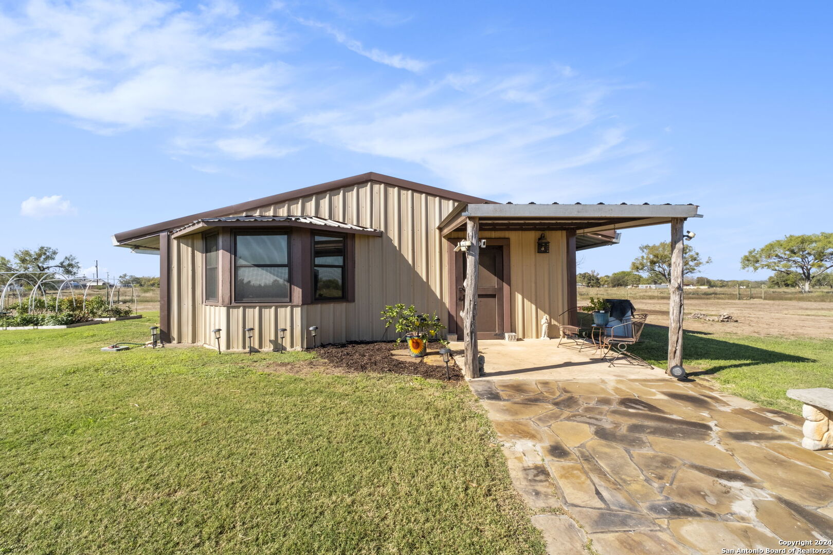 a view of a house with backyard porch and sitting area