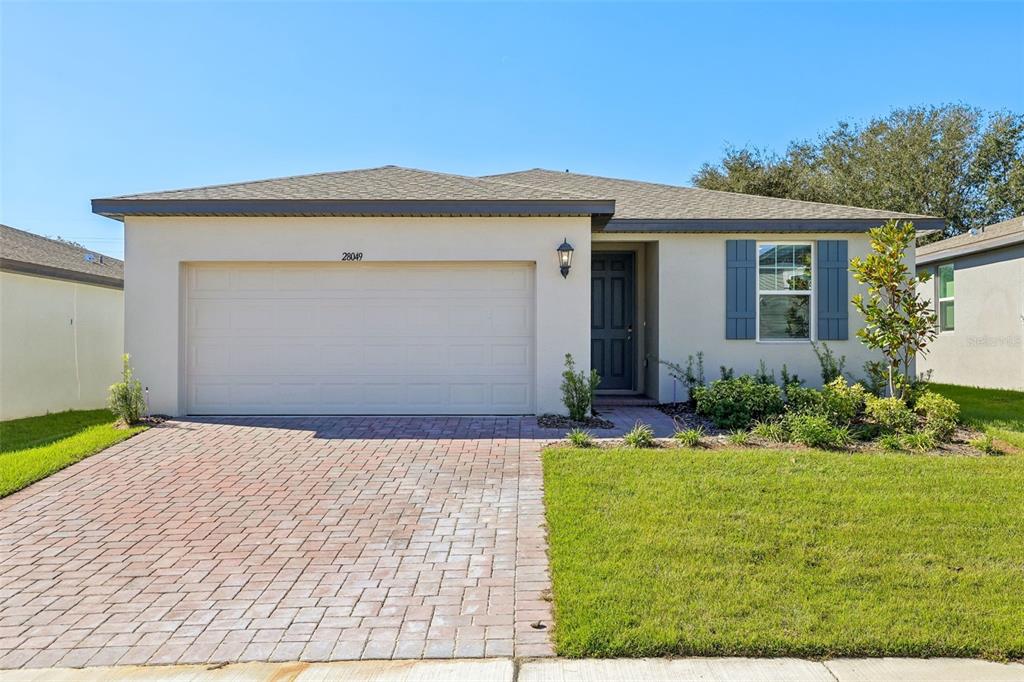 a front view of a house with a yard and garage