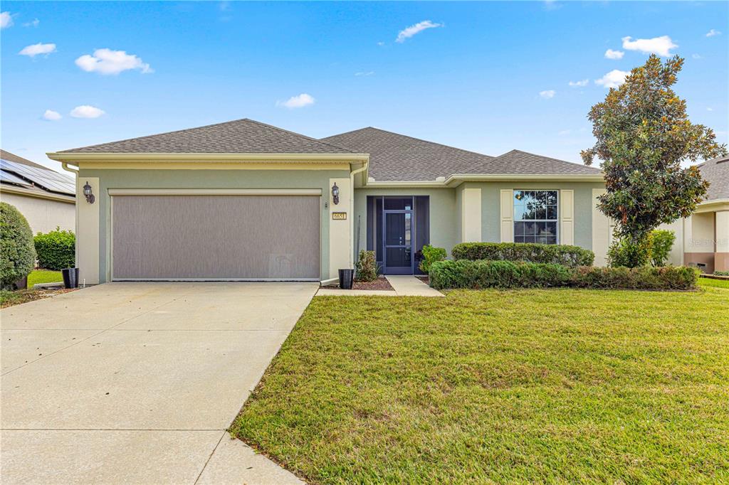 a front view of a house with a yard and garage