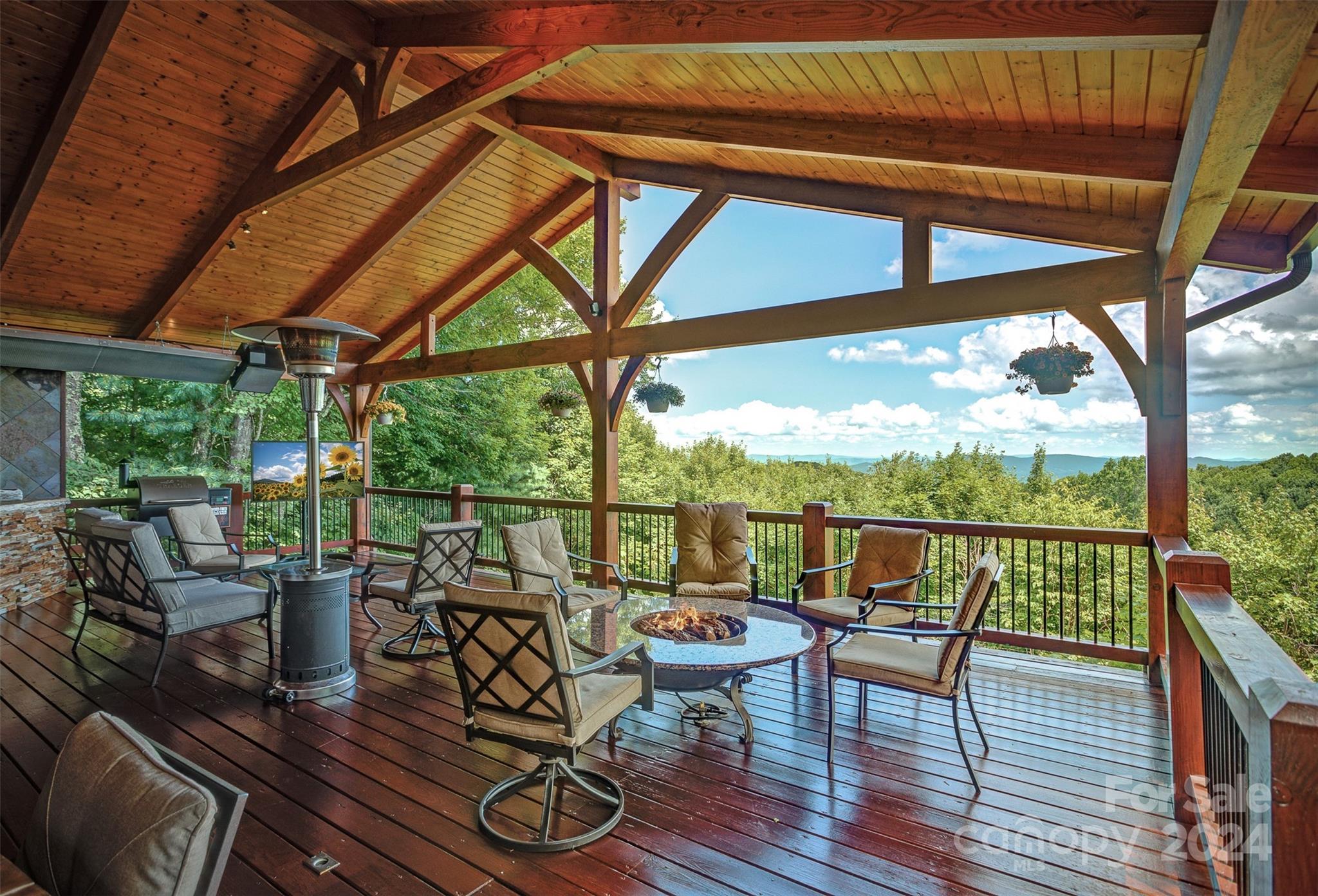 a view of a patio with chairs and table under an umbrella