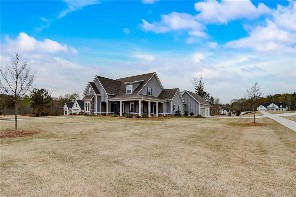 a front view of a house with a yard and garage