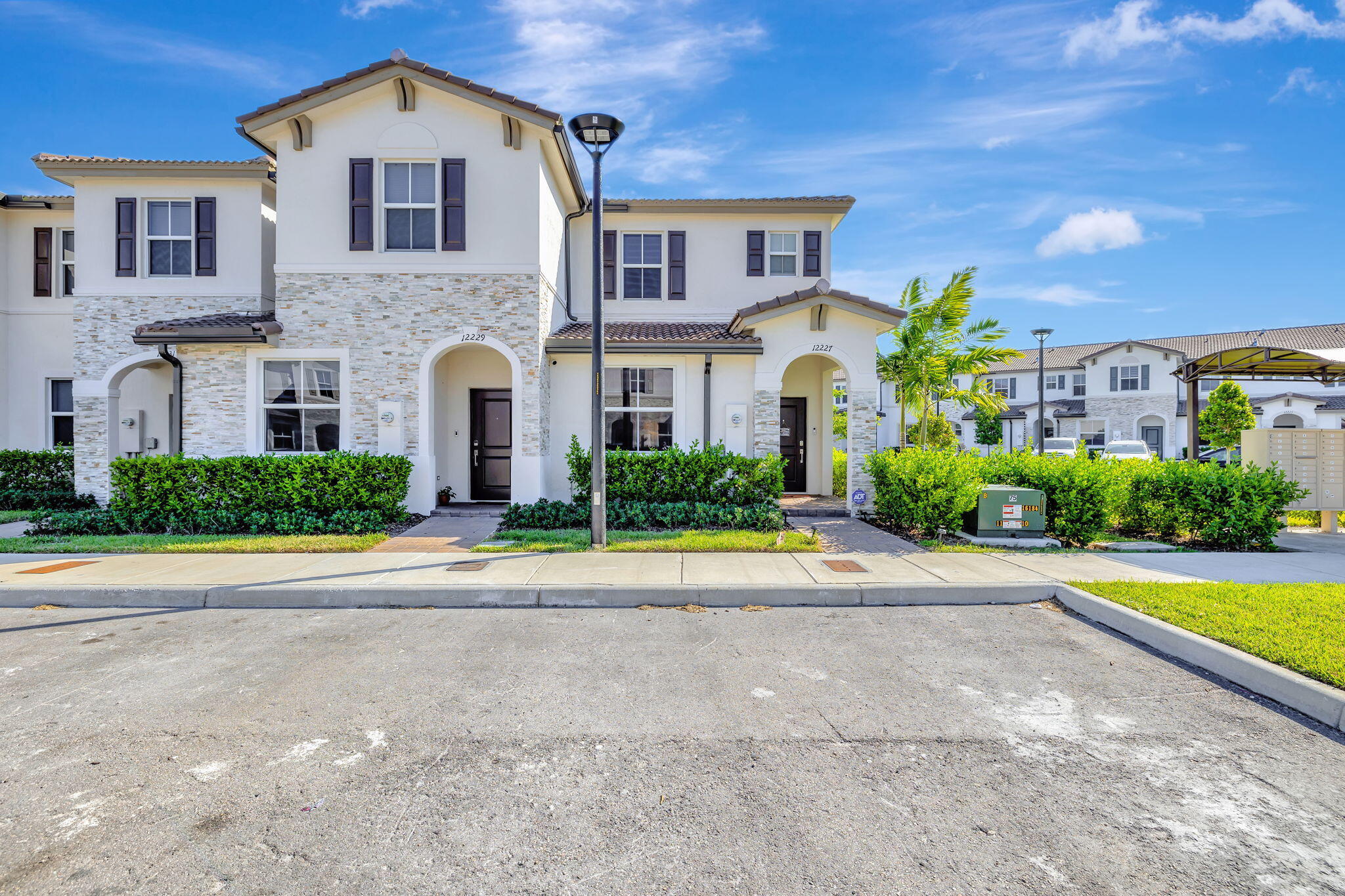 a front view of a house with a yard and a garage