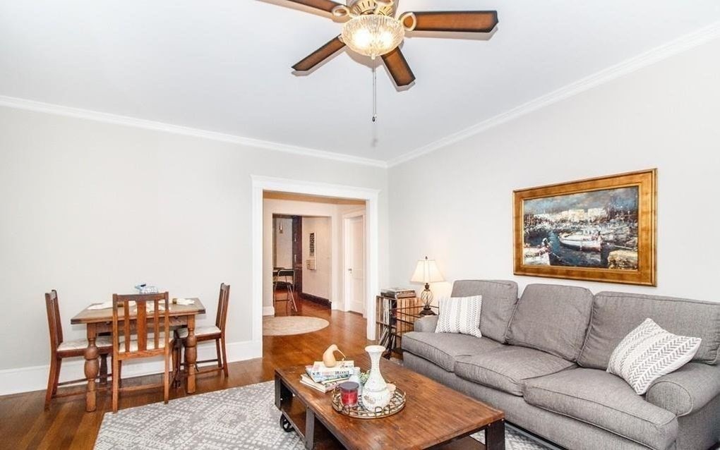 a living room with furniture and a dining table