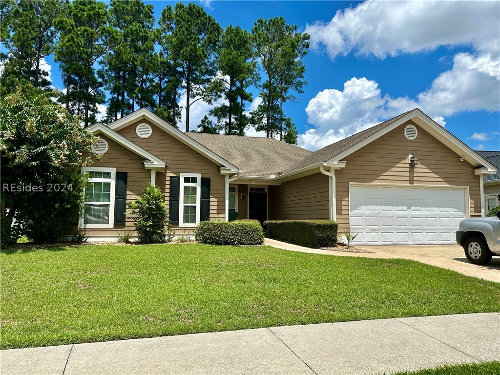 Ranch-style house with a garage and a front yard