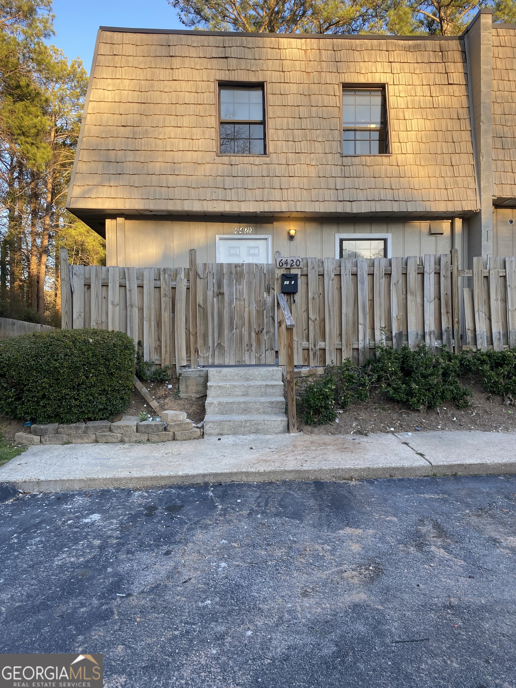 a view of a house with a yard and garage