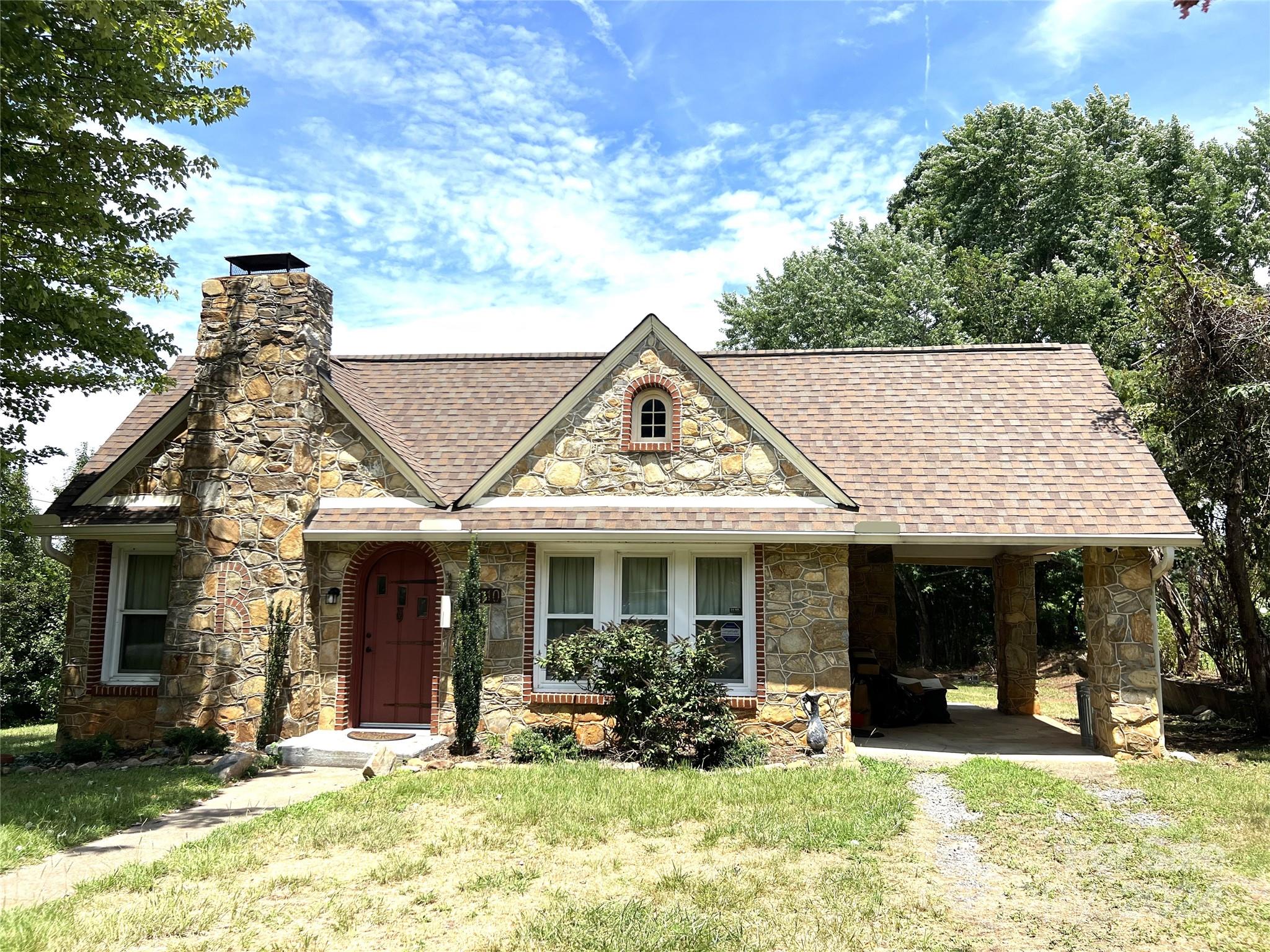 front view of a house with a yard outdoor seating and a yard