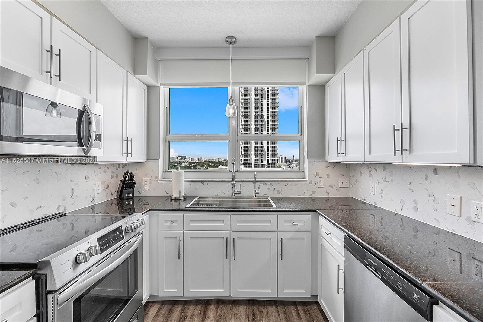 a kitchen with stainless steel appliances white cabinets and a sink