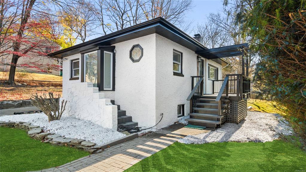 View of side of home featuring a yard