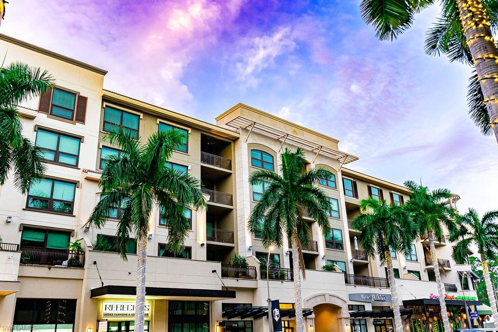 a front view of residential houses with palm trees